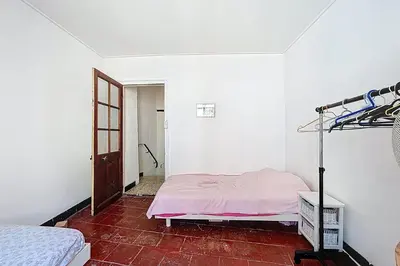 a white room with a bed and a ladder in it at Charming house with terrace and breathtaking views in Bages