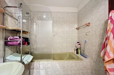a bathroom with a green tub and a sink at Charming house with terrace and breathtaking views in Bages