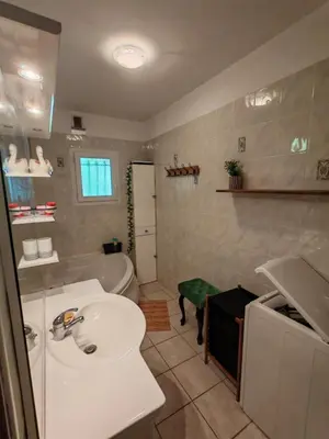 a bathroom with a sink and a toilet and a tub at L'Eau Vive Villa 6 pers parc 3000m2 à 50 m de la rivière in Fraisse-sur-Agout