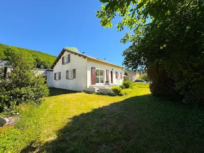 a house on a grassy yard with a tree at L'Eau Vive Villa 6 pers parc 3000m2 à 50 m de la rivière in Fraisse-sur-Agout