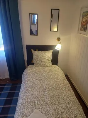 a bed in a bedroom with a lamp on it at Chez Pet and Jo in Olargues
