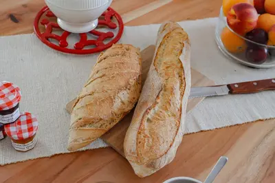 two slices of bread on a table with a cup of coffee at L'Escapade Jaune - Jacuzzi, Wi-Fi, tout équipée in Carcassonne