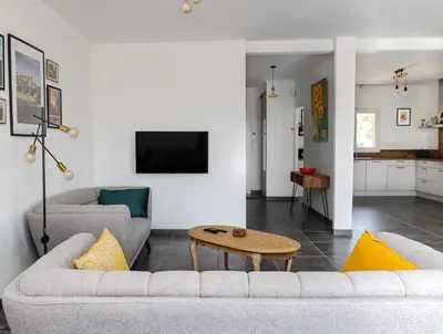 a living room with two couches and a table at L'Escapade Jaune - Jacuzzi, Wi-Fi, tout équipée in Carcassonne