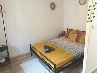 a bedroom with a bed with a hat on it at Appartement Du DONJON in Carcassonne