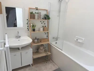 a bathroom with a sink and a mirror and a tub at Appartement Du DONJON in Carcassonne