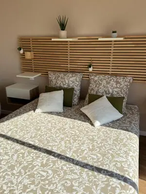 a bedroom with a large bed with two pillows at Modern villa with sea view in Fitou