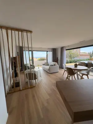 a living room with a couch and a table at Modern villa with sea view in Fitou