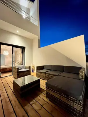 a living room with a couch and a table at Modern villa with sea view in Fitou