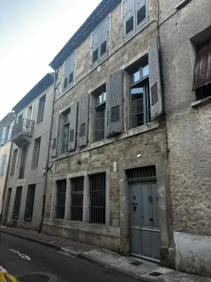 an old brick building with a door on a street at Maison Gally Historic Luxury in Carcassonne