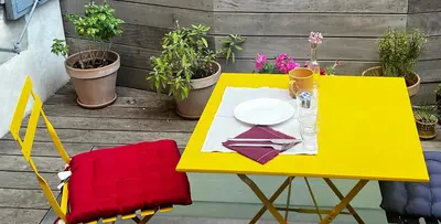a yellow table with a plate and a red chair at Maison Gally Historic Luxury in Carcassonne