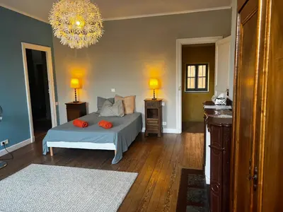 a bedroom with a bed with orange pillows on it at Maison Gally Historic Luxury in Carcassonne