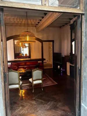 a living room with two chairs and a chandelier at Maison Gally Historic Luxury in Carcassonne