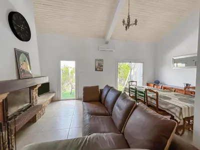 a living room with a couch and a table at Maison avec Jardin, Terrasse, cheminée insert et bois in Carcassonne