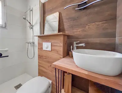 a bathroom with a white sink and a toilet at Maison avec Jardin, Terrasse, cheminée insert et bois in Carcassonne