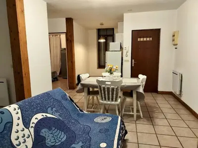 a kitchen and dining room with a table and a couch at Apartment 6 in Castelnaudary