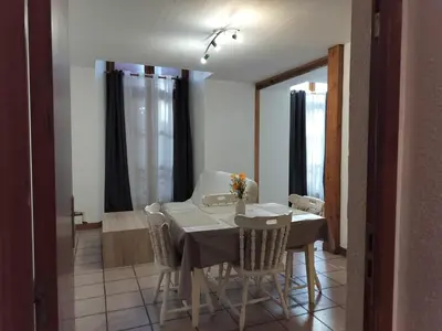a dining room with a white table and chairs at Apartment 6 in Castelnaudary