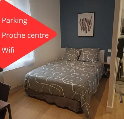a bedroom with a bed and a red sign that says private centre at Chambre avec salle de bain privative in Castres