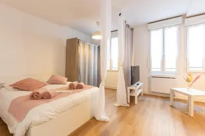 a bedroom with a bed with two towels on it at Grand Studio Centre Castres in Castres