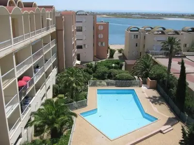 an aerial view of a building with a swimming pool at Le Thalassa II in Gruissan