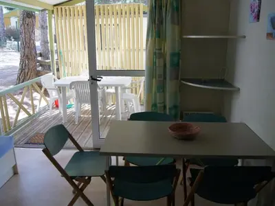 a table and chairs in a room with a balcony at Chalet confortable avec terrasse à Sournia - API-1-52-491 in Sournia