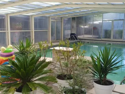 a swimming pool with plants in front of a building at Mobil-home confortable avec terrasse pour 4 personnes à Sournia - API-1-52-622 in Sournia