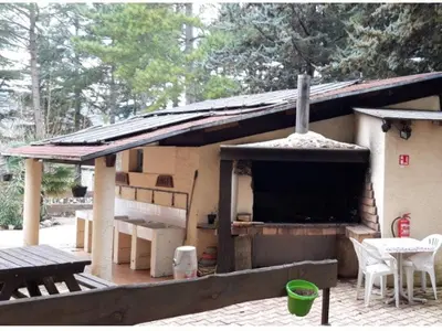 a small house with a porch and a table at Mobil-home confortable avec terrasse pour 4 personnes à Sournia - API-1-52-622 in Sournia