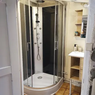 a shower with a glass enclosure in a bathroom at Chalet atypique in Anglès