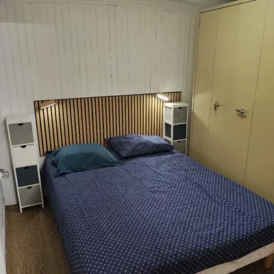 a bedroom with a bed with a blue comforter at Chalet atypique in Anglès