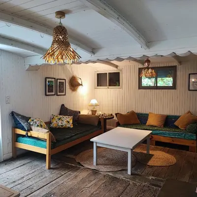 a living room with two couches and a table at Chalet atypique in Anglès