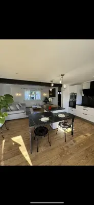 a large living room with a table and chairs at La villa des lauriers in Cuxac-dʼAude
