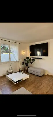 a living room with a couch and a table at La villa des lauriers in Cuxac-dʼAude