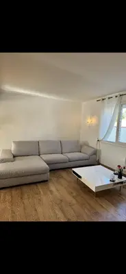 a living room with a couch and a coffee table at La villa des lauriers in Cuxac-dʼAude