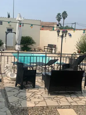 a patio with chairs and a swimming pool at La villa des lauriers in Cuxac-dʼAude