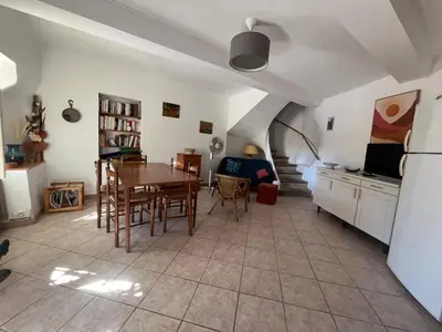 a kitchen and dining room with a table and chairs at Charmante maison de village à Tourouzelle in Tourouzelle