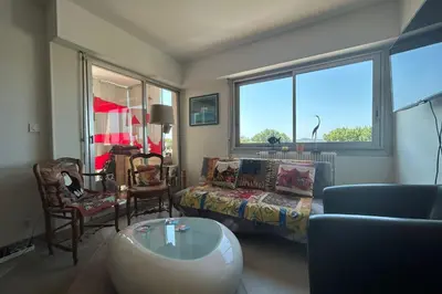 a living room with a couch a bed and a table at Apartment with view quiet and comfort in Narbonne in Narbonne