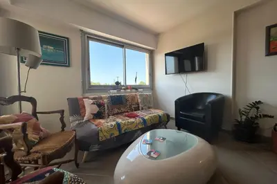 a living room with a couch and a chair at Apartment with view quiet and comfort in Narbonne in Narbonne