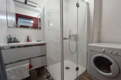 a bathroom with a shower and a washing machine at Apartment with view quiet and comfort in Narbonne in Narbonne