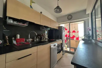 a kitchen with a sink and a stove top oven at Apartment with view quiet and comfort in Narbonne in Narbonne