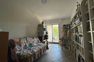 a living room with a couch and a window at Apartment with view quiet and comfort in Narbonne in Narbonne