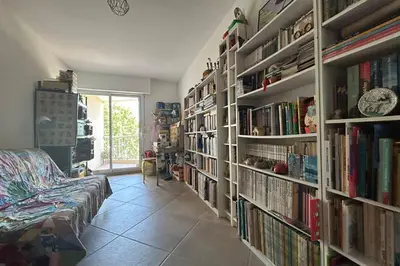 a room with several shelves filled with books at Apartment with view quiet and comfort in Narbonne in Narbonne