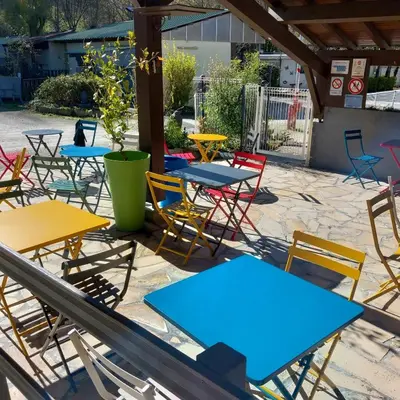 a group of tables and chairs on a patio at Mobil Home La Belle Vie in Vaudreuille