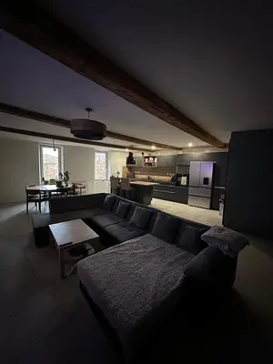 a living room with a couch and a kitchen at Asta house in Cébazan