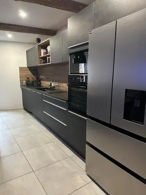 a kitchen with a stainless steel refrigerator and appliances at Asta house in Cébazan