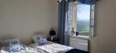 a bedroom with a bed and a window at Chambre des Remparts in Lautrec