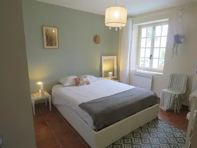 a bedroom with a white bed and a window at Chambre des Remparts in Lautrec