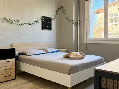 a bedroom with a bed and a window at L'Horizon de la Cité in Carcassonne