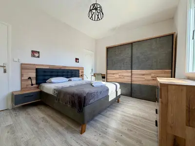 a bedroom with a large bed in a room at L'Horizon de la Cité in Carcassonne