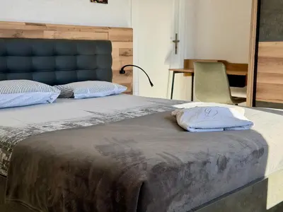 a bed with two pillows on top of it at L'Horizon de la Cité in Carcassonne