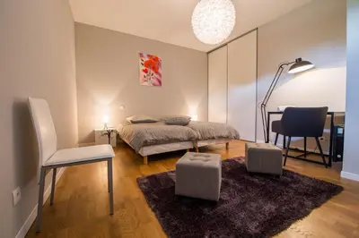 a bedroom with a bed and a table and a chair at l'Ecrit Vin in Rustiques