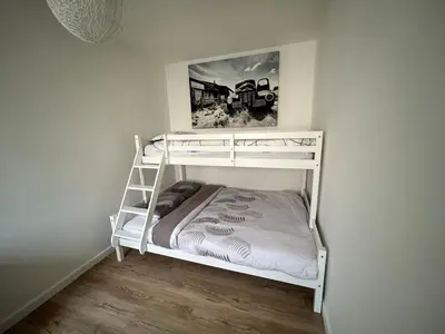 a white bunk bed in a white room at Appartement au calme commerces à proximité in Castres